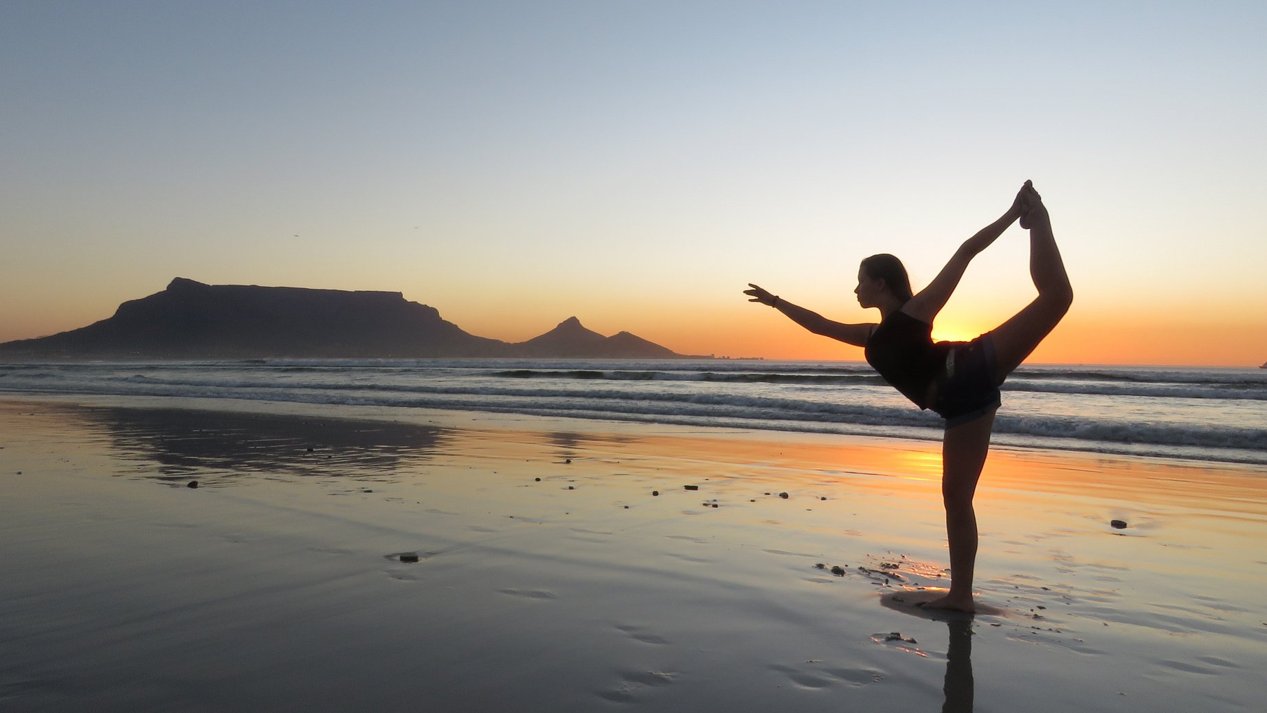 Silhouette of Woman Doing Yoga at the Beach